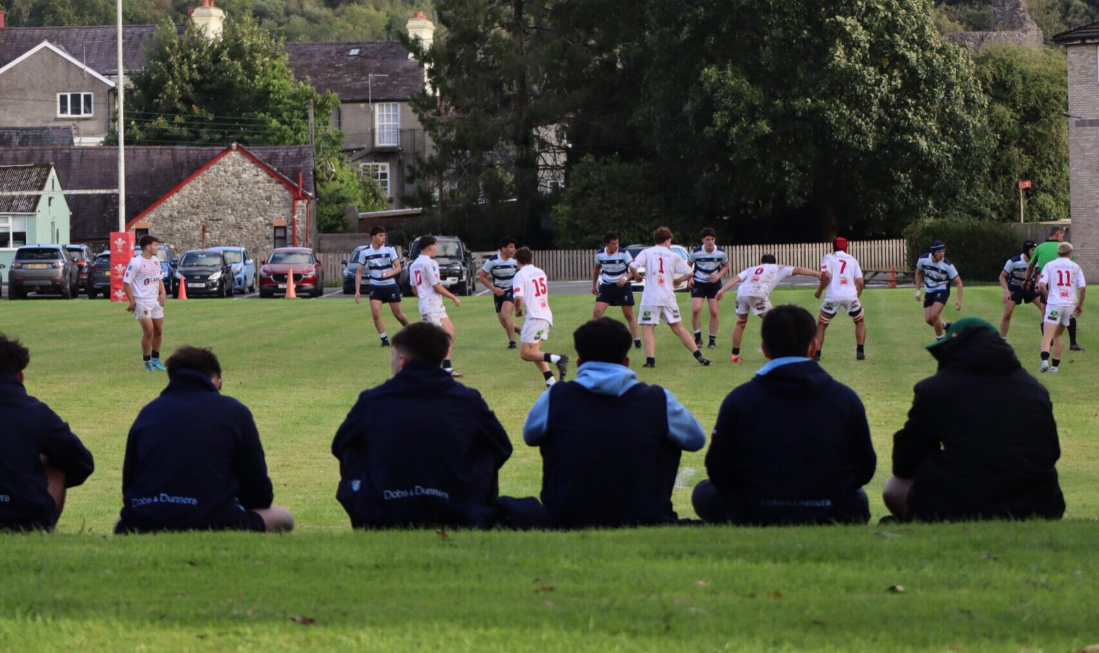 Pupils watching a match from the grass bank