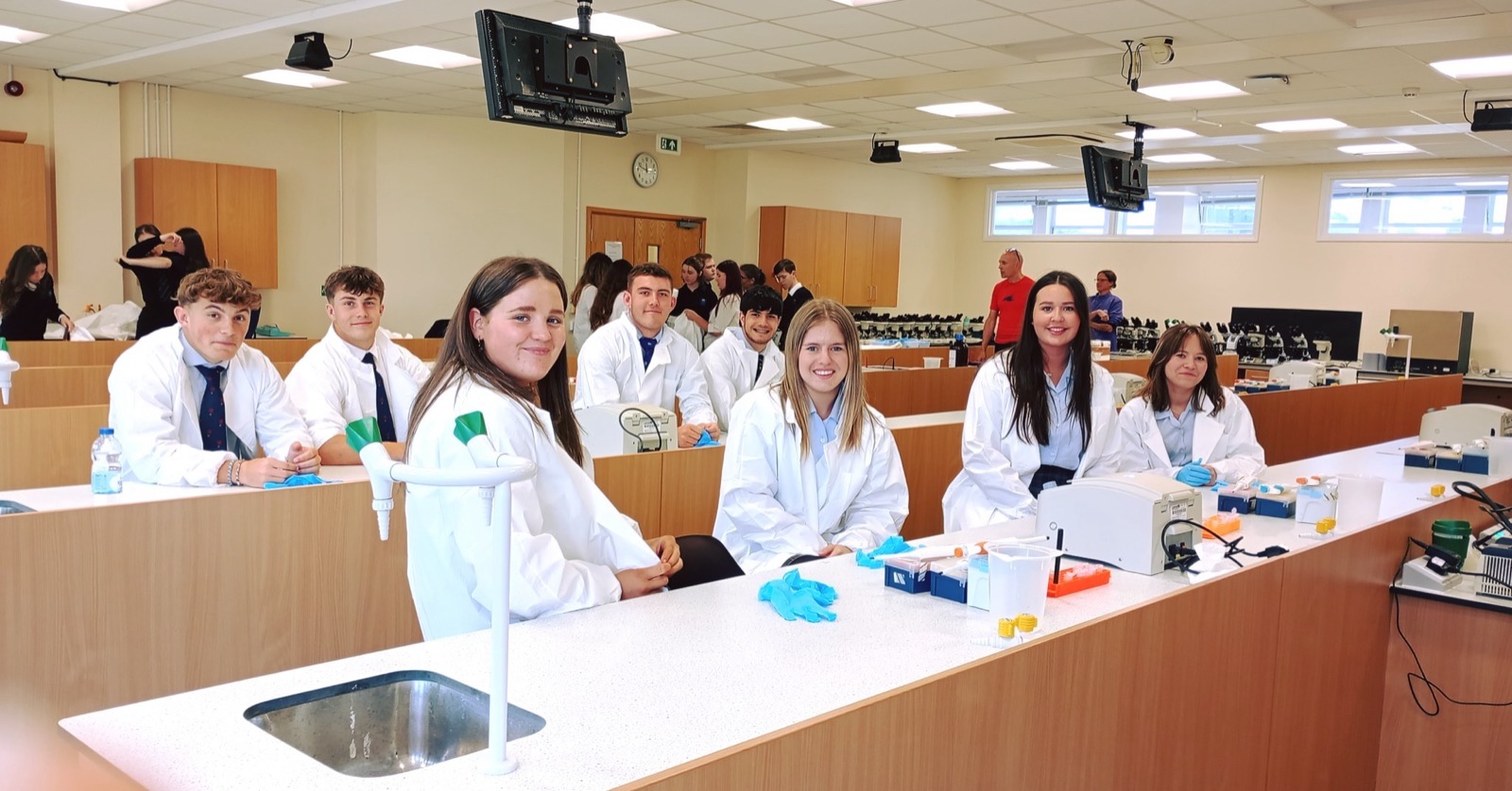 Pupils in lab coats in a science class